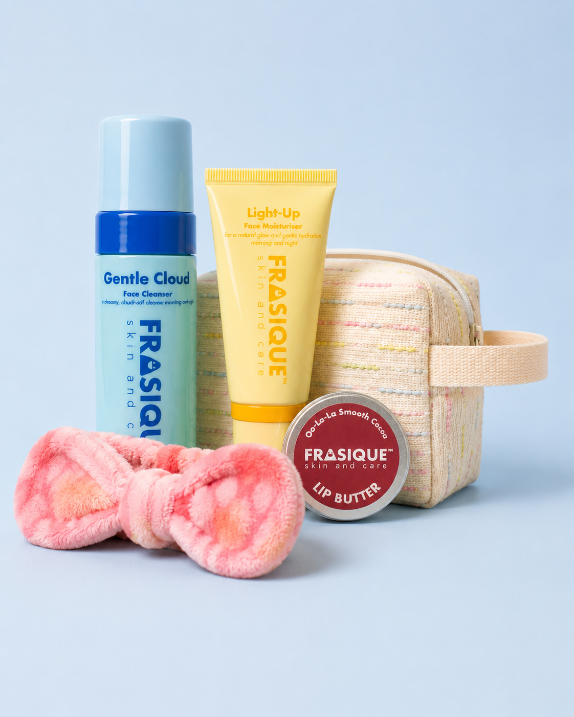 FRASIQUE skincare product bundles for tweens and teens including a face cleanser, face moisturiser, lip balm, headband and toiletry bag on a light blue background.