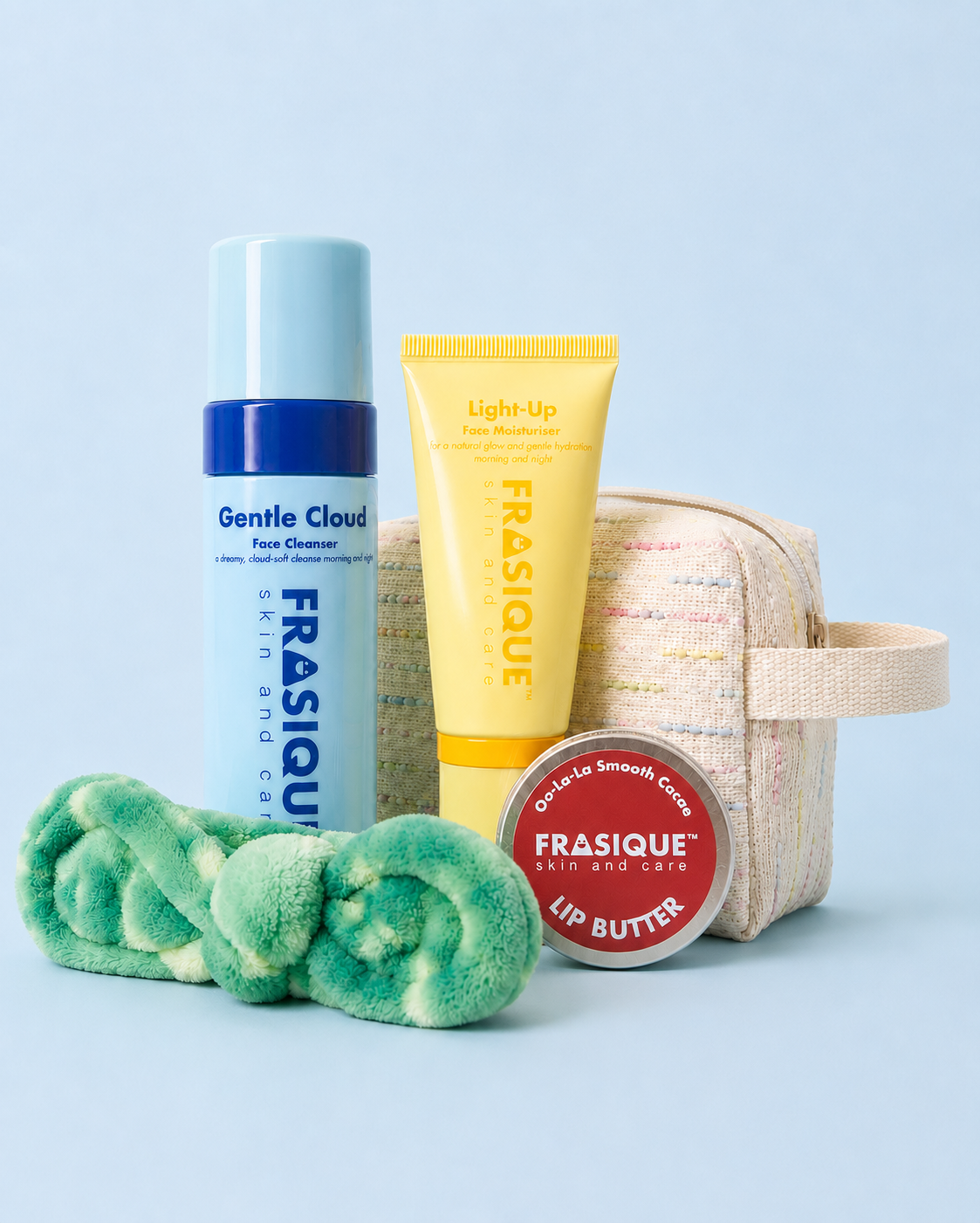 FRASIQUE skincare product bundles for tweens and teens including a face cleanser, face moisturiser, lip balm, headband and toiletry bag on a light blue background.